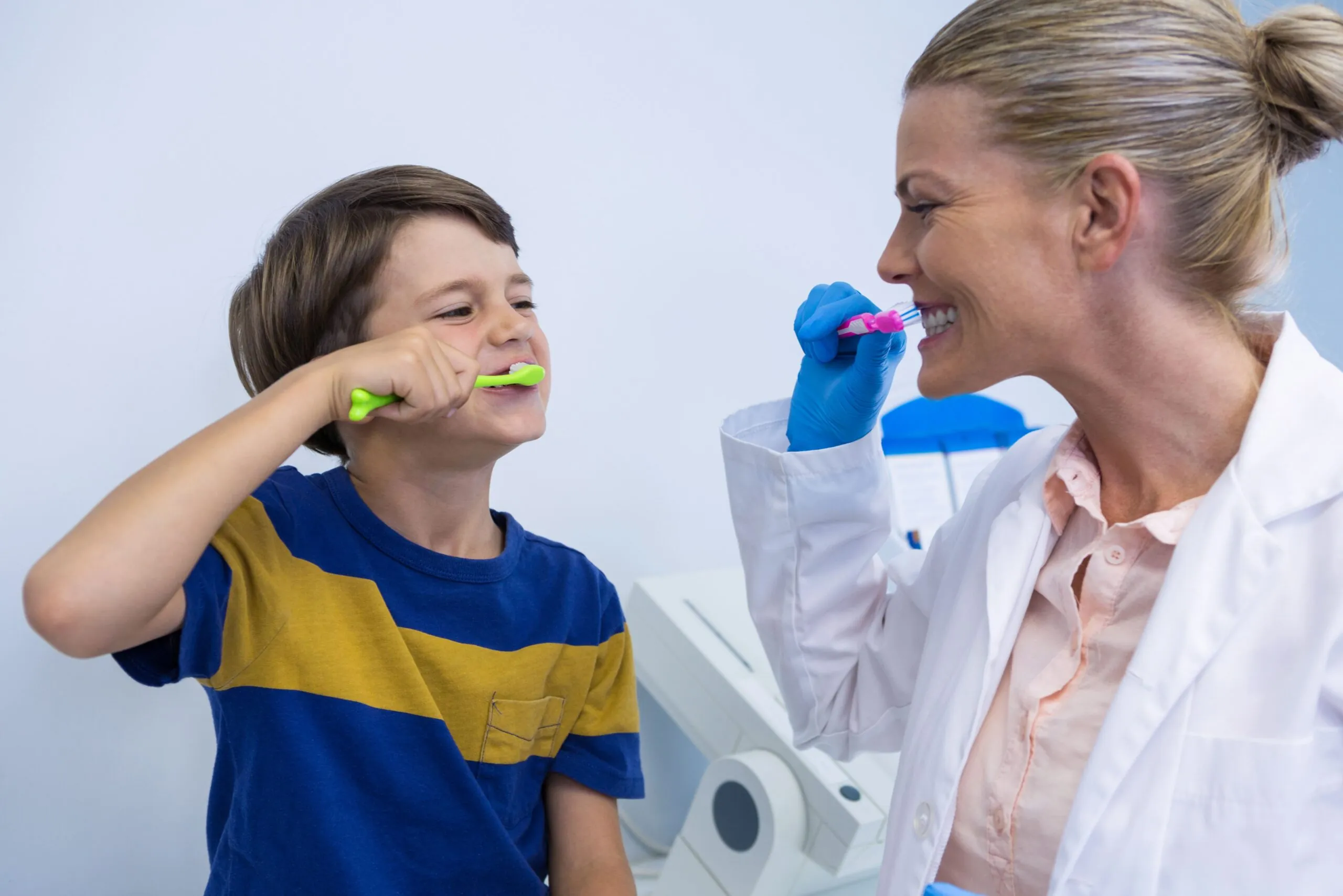 Children with Autism 23 happy-dentist-and-boy-brushing-teeth-against-wall