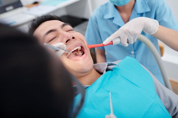 dentist checking teeth of patient