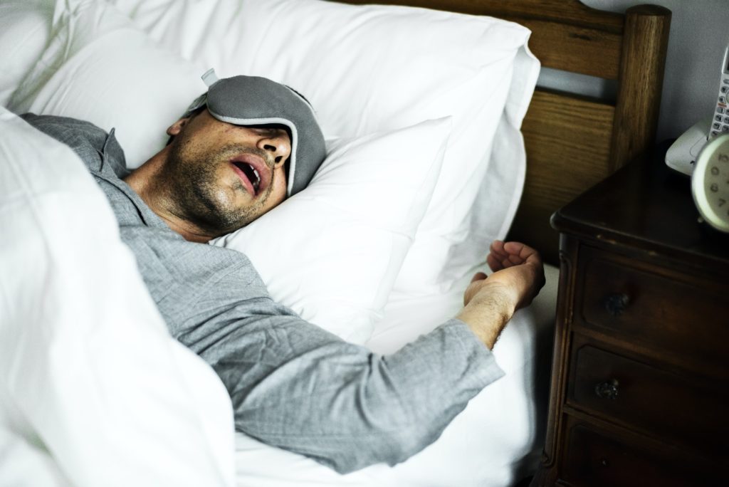 a man sleeping on a bed