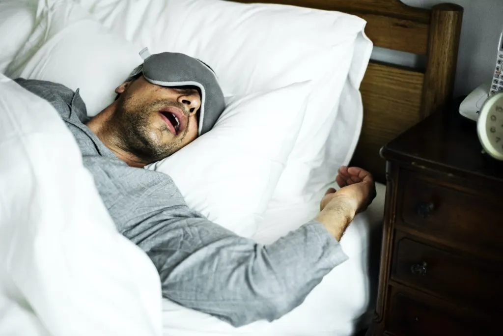 Sleep Apnea 6 A man sleeping on a bed
