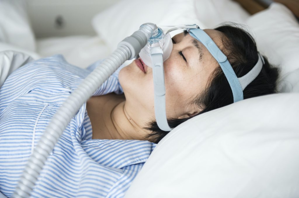 a woman wearing anti snoring chin straps