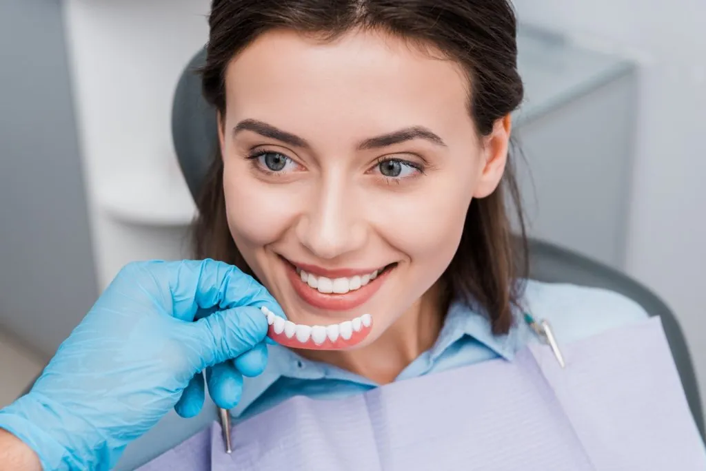 Snap on Smile 6 dentist holding prosthesis