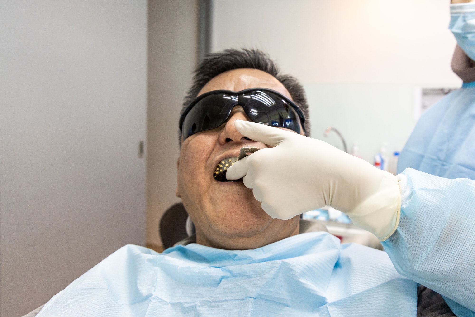 Dentist taking teeth imprint or impression of patient in dental clinic