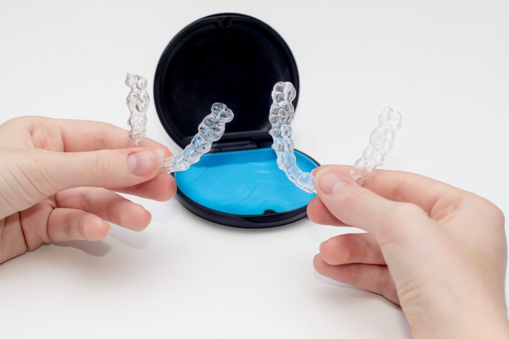 Invisalign aligners and storage case. Invisible braces. Clear teeth straighteners. plastic bracers