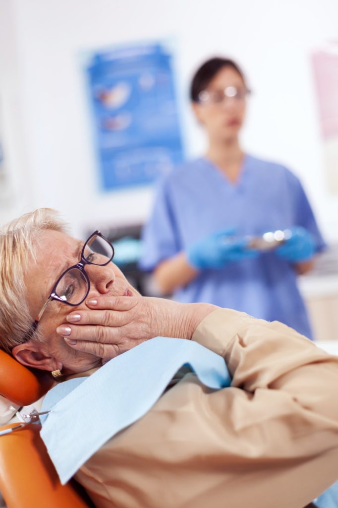 Root Canal 3 Middle age patient touching mouth with painful expression