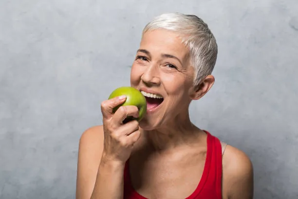 Dental Bridge 6 Older woman biting an apple