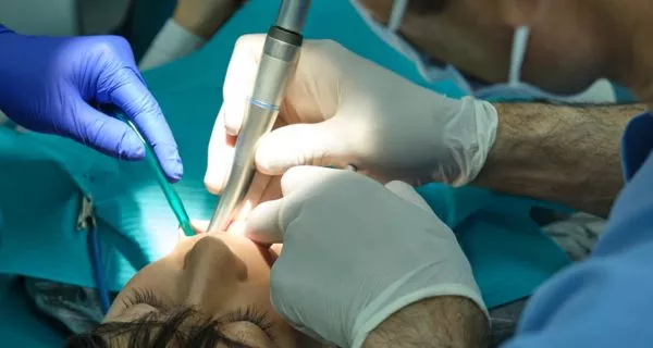 What procedures does a root canal specialist perform?